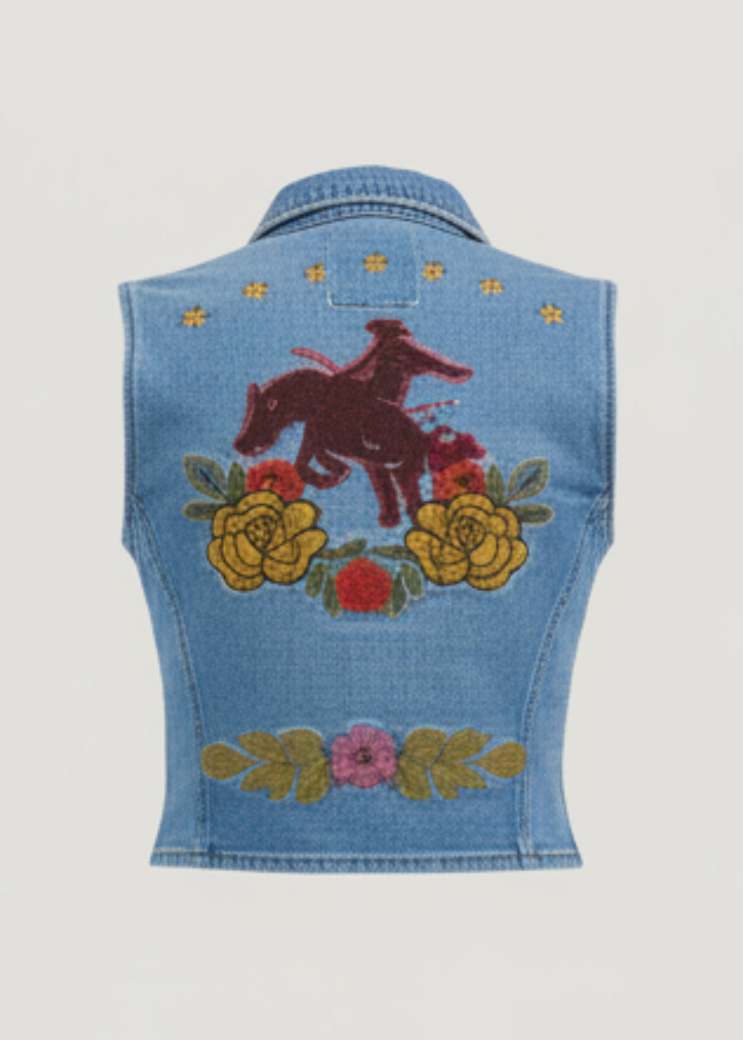 Denim outfit with embroidered top on a white background