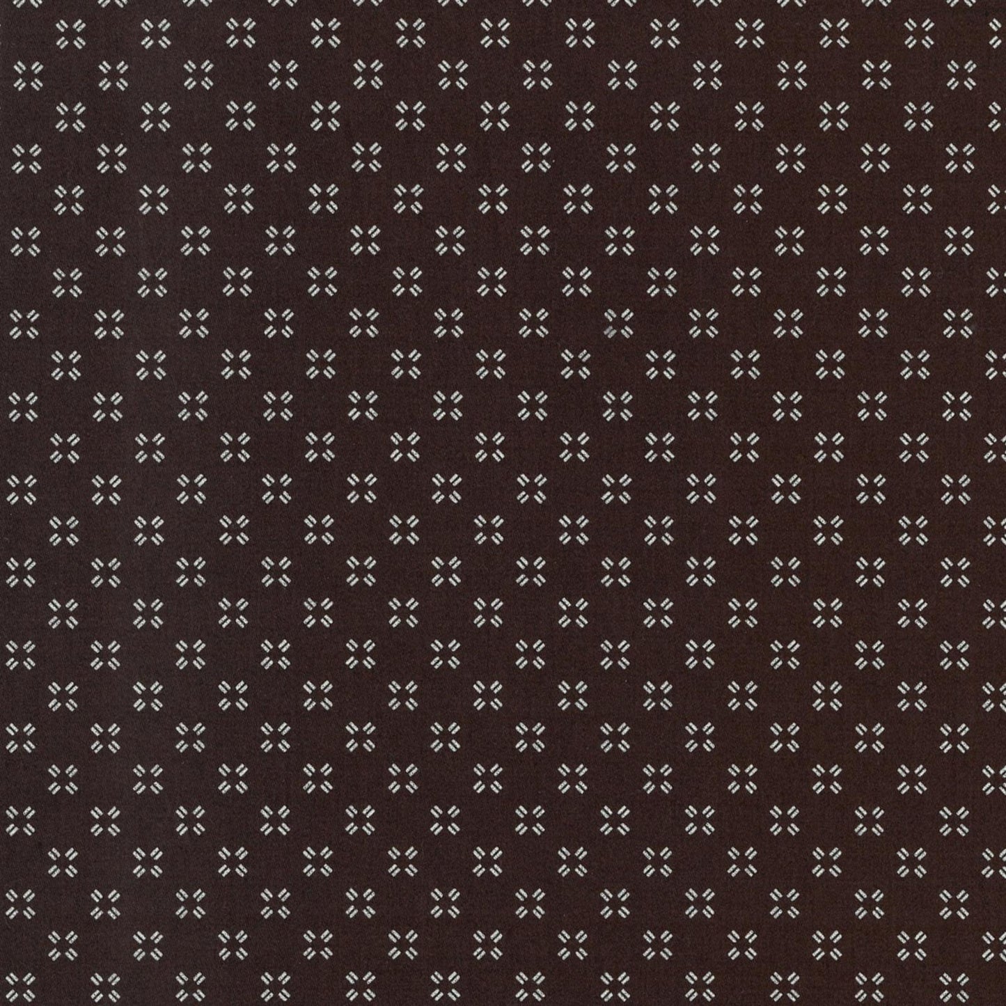 Patterned fabric with small geometric design on a brown background