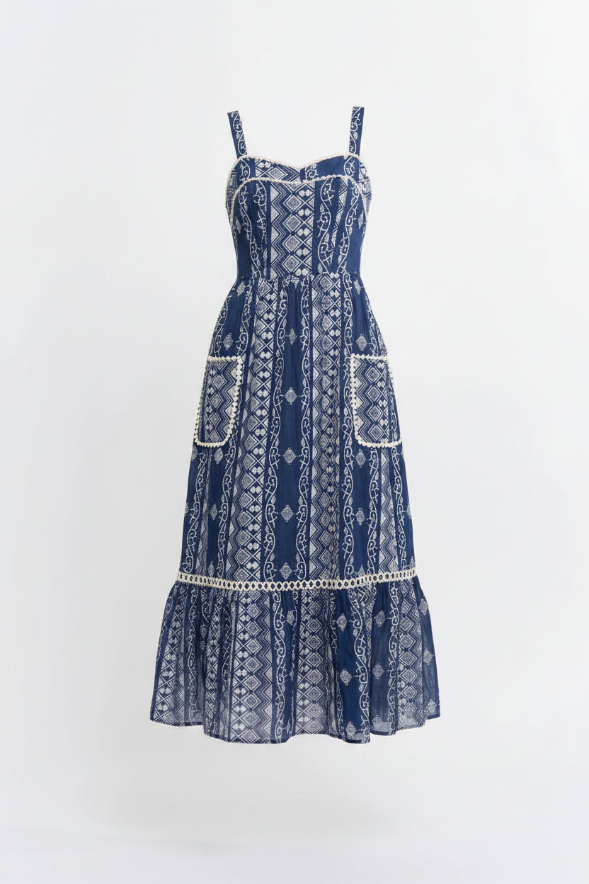 Woman wearing a blue patterned dress on a white background