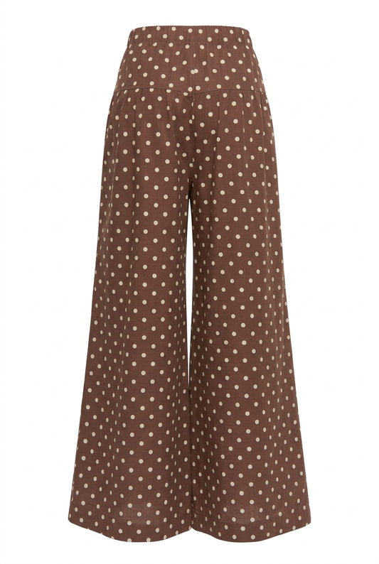 Back view of brown wide leg pants with cream polka dots and a relaxed silhouette.