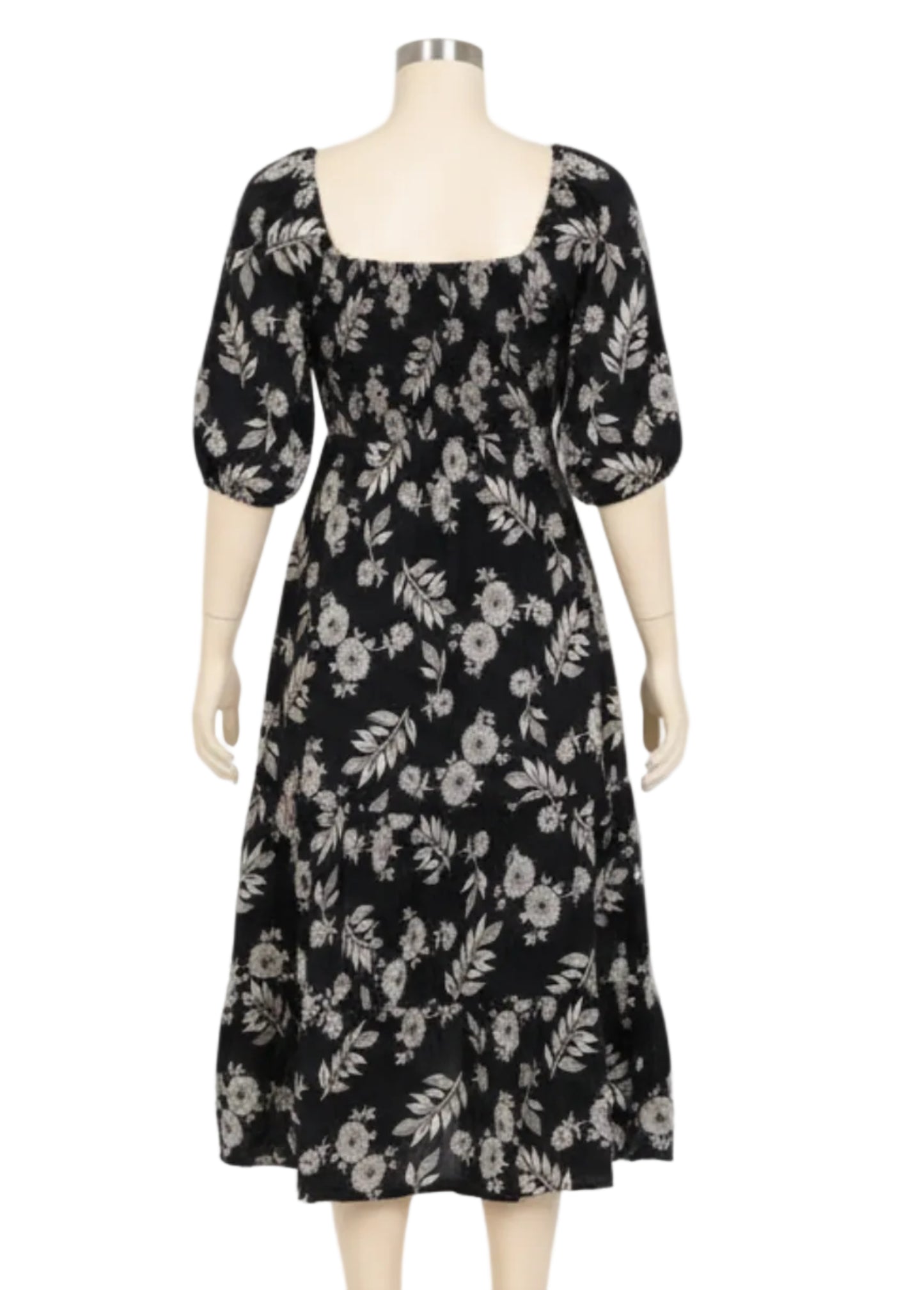 Woman wearing a black floral dress on a white background