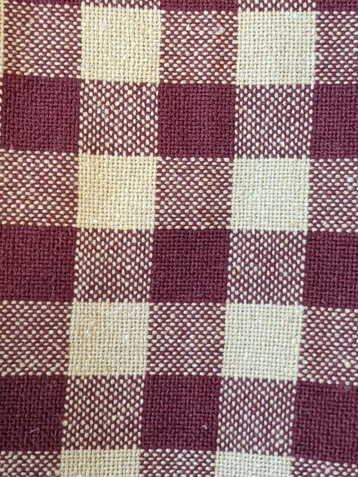 Close-up of Pip Vinestar kitchen towel fabric showing burgundy and cream checks and woven texture