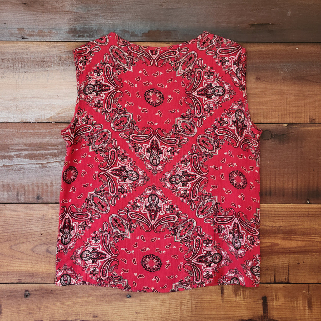 Red paisley patterned top on a wooden background
