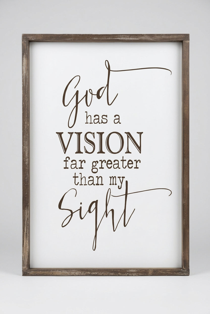 Rustic brown framed wall art with black lettering reading God has a vision far greater than my sight on a cream background