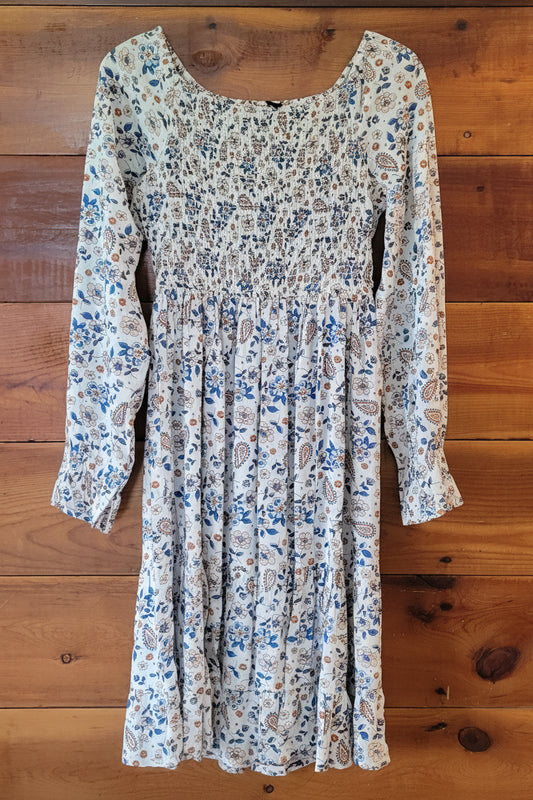 Floral-patterned dress on a wooden surface