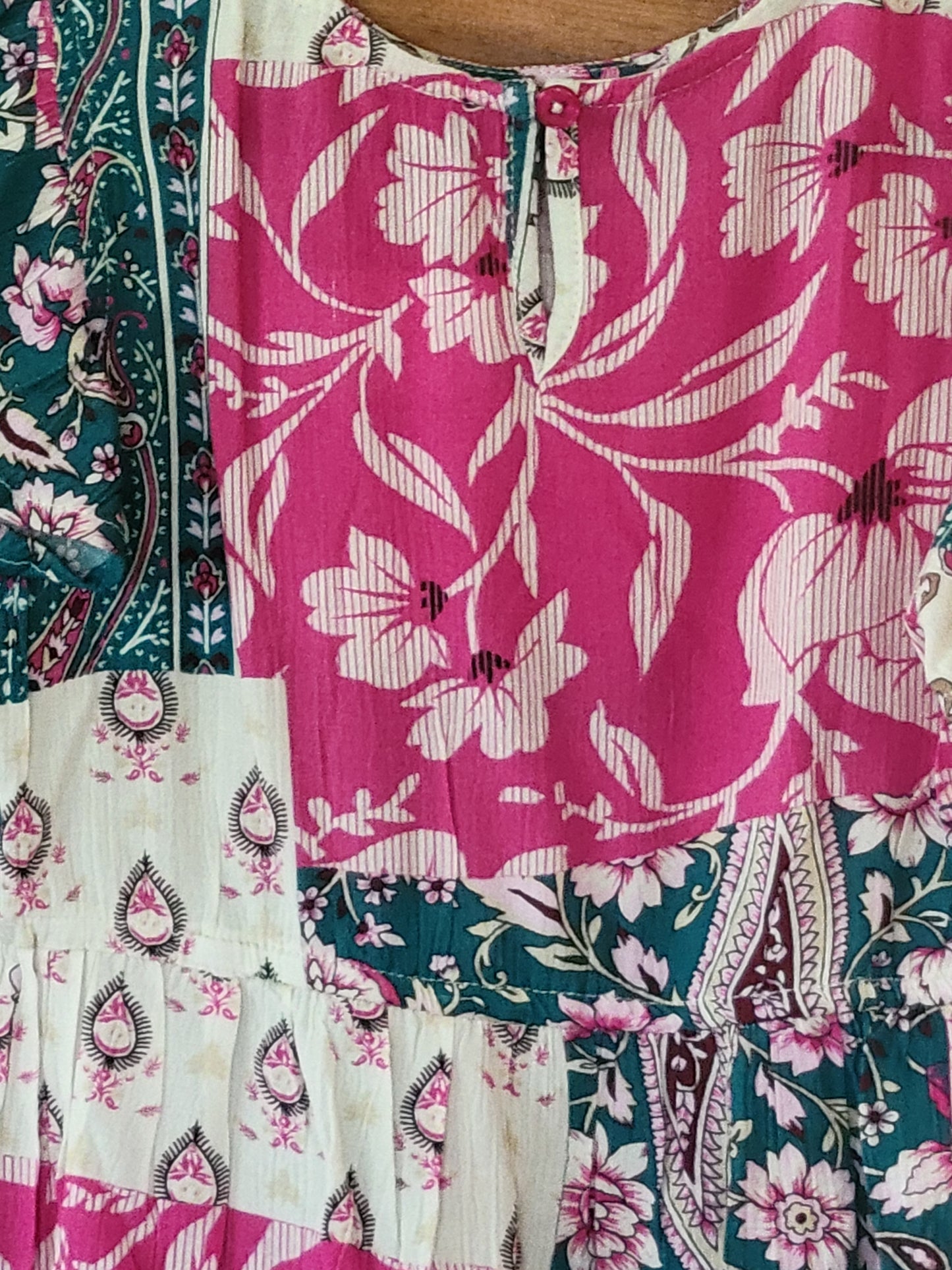 Patterned dress showing back button in the neck opening