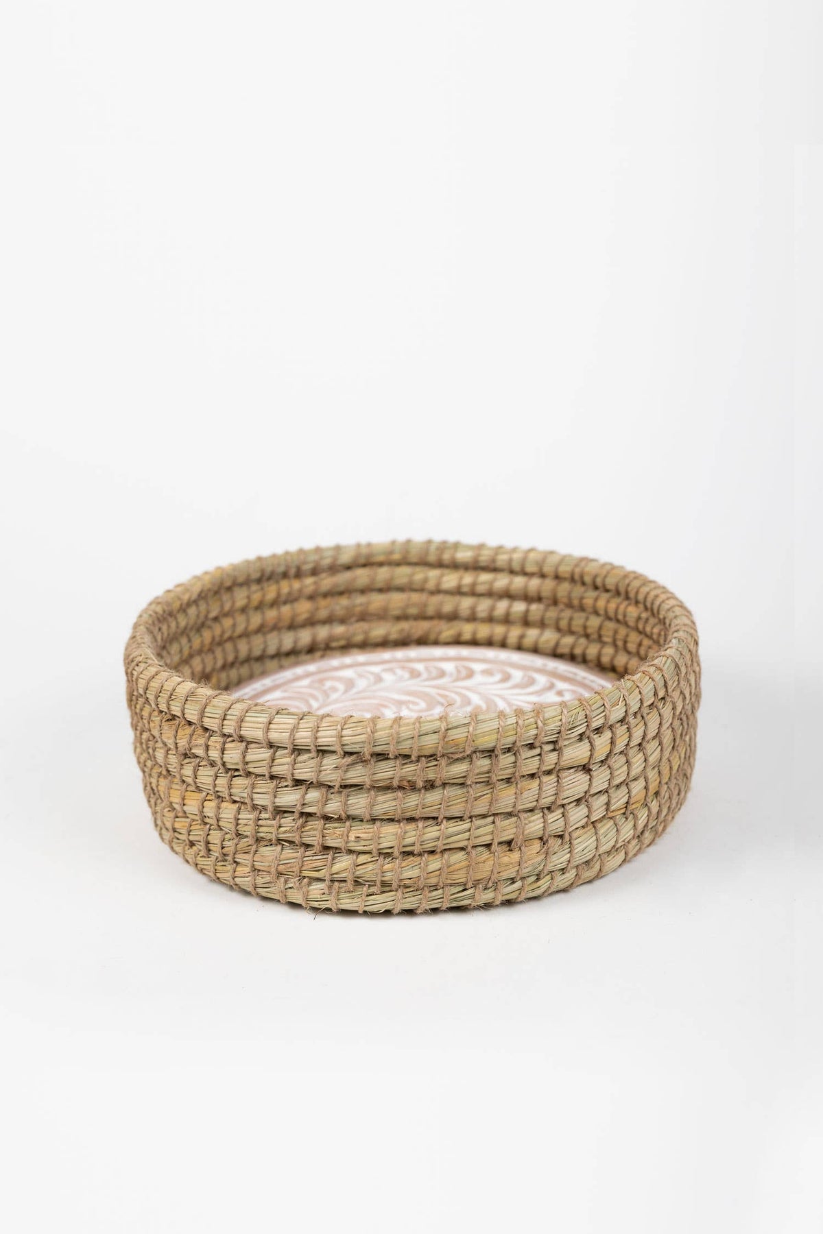 Side view of the Toasty Round Bread Basket showing its natural woven sides and whitewashed terracotta insert