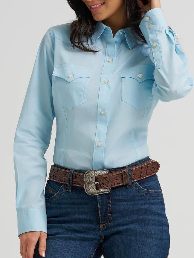 Woman wearing a light blue shirt and dark blue jeans on a white background