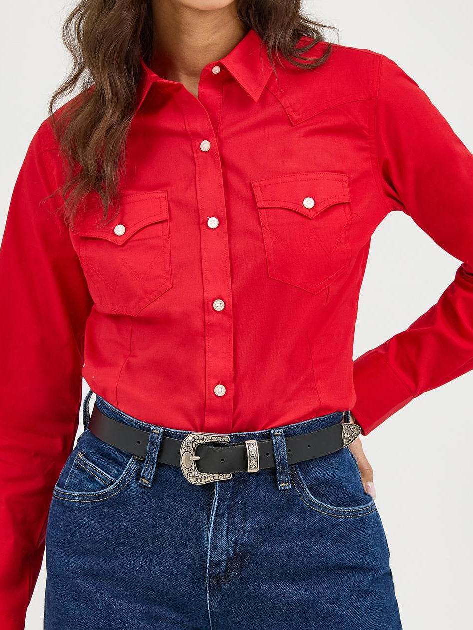 Person wearing a red shirt, blue jeans, and a black cowboy hat on a white background