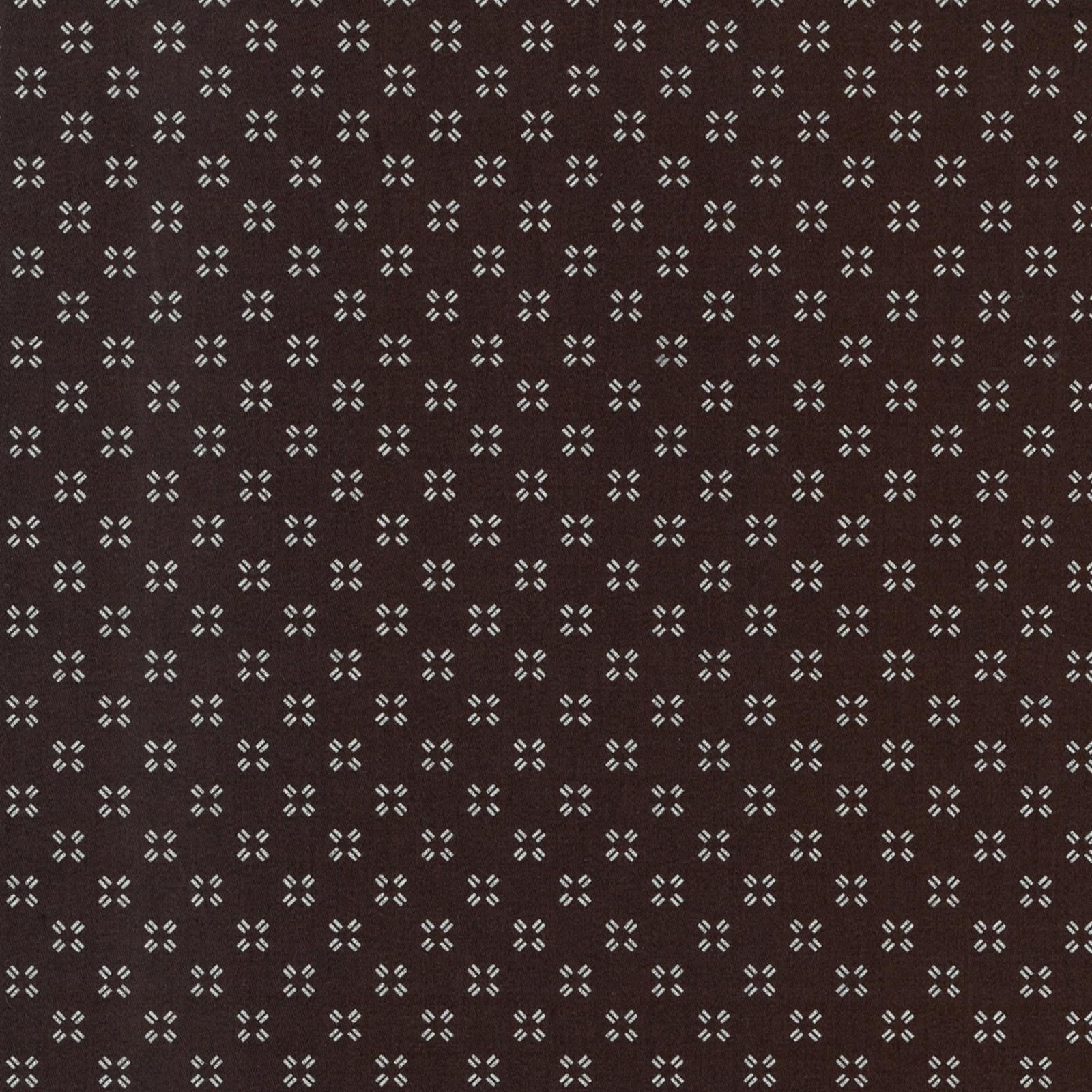 Patterned fabric with small geometric design on a brown background