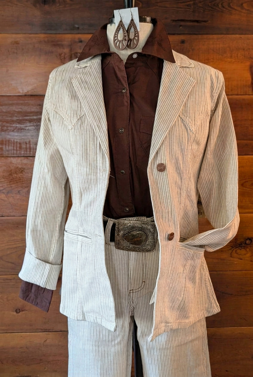 Brown Wrangler Retro statement collar shirt layered under a cream pinstriped blazer with a decorative Western belt.
