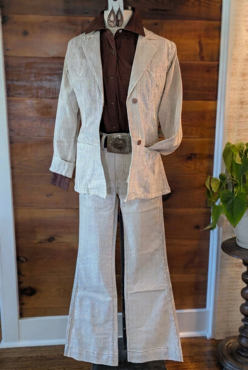Full-length outfit featuring a brown Wrangler Retro shirt with a matching cream pinstriped blazer and wide-leg pants.