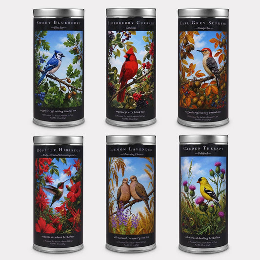 Six bird-themed tea tins featuring a blue jay, cardinal, woodpecker, hummingbird, mourning doves, and goldfinch