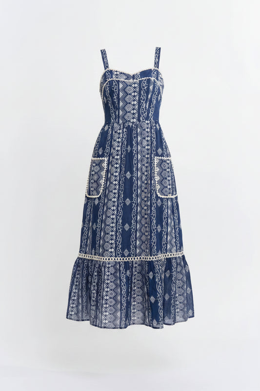Woman wearing a blue patterned dress on a white background