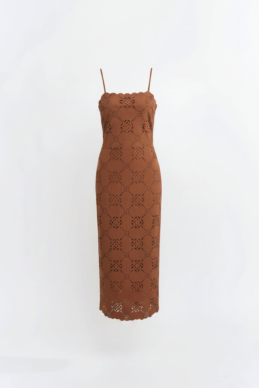  a brown lace midi dress with thin straps and a fitted silhouette, standing against a plain white studio background.