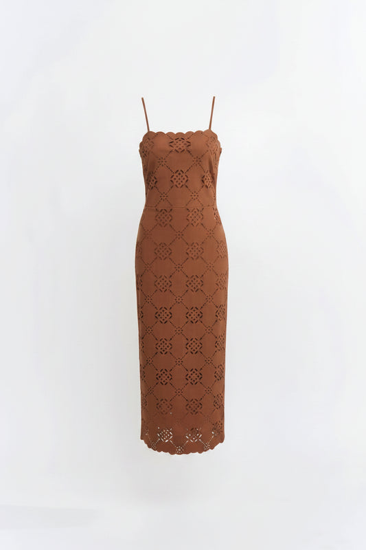  a brown lace midi dress with thin straps and a fitted silhouette, standing against a plain white studio background.
