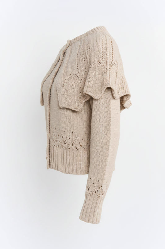 Beige knitted cardigan with lace details on a white background