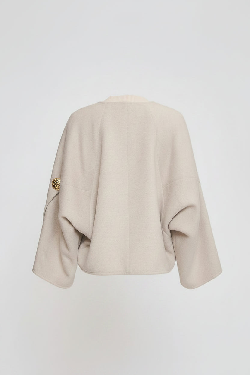  beige jacket a plain background
