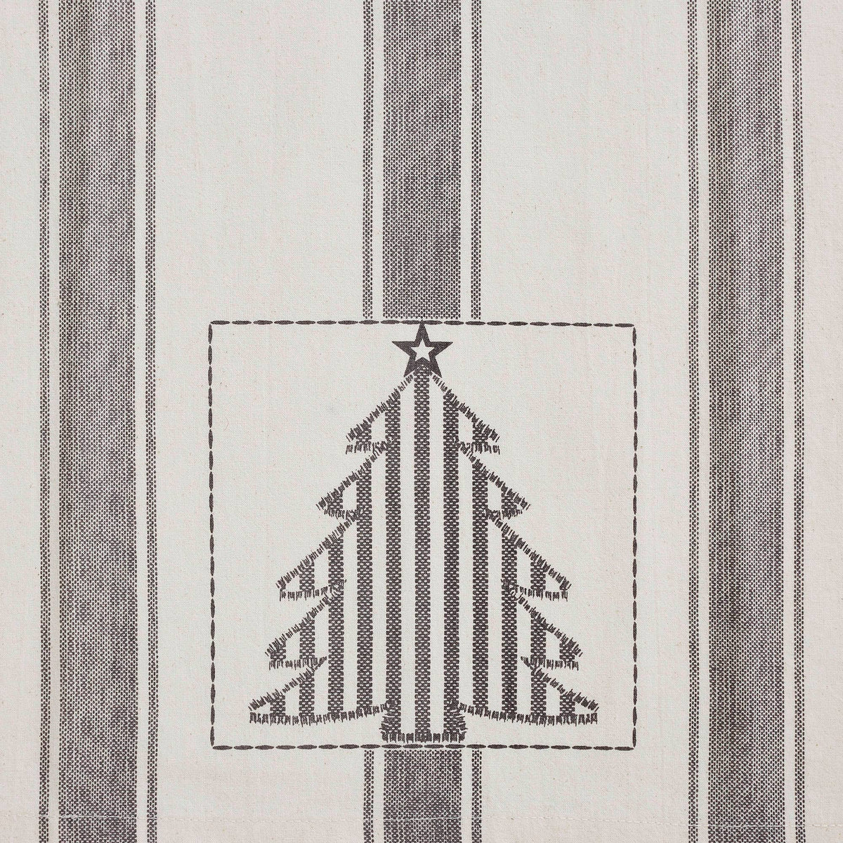 Close-up of a gray striped Christmas tree with a star topper on a cream Grace tea towel.