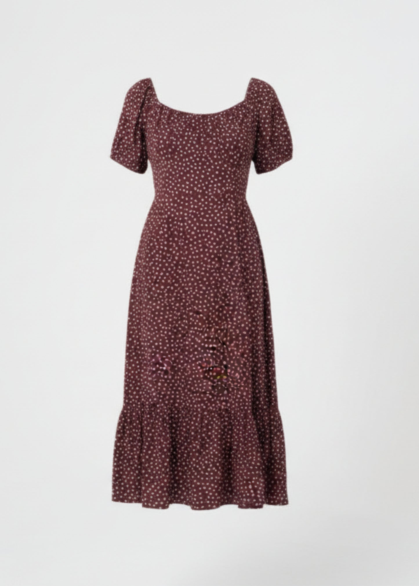 Woman wearing a chocolate dress with white polka dots on a white background