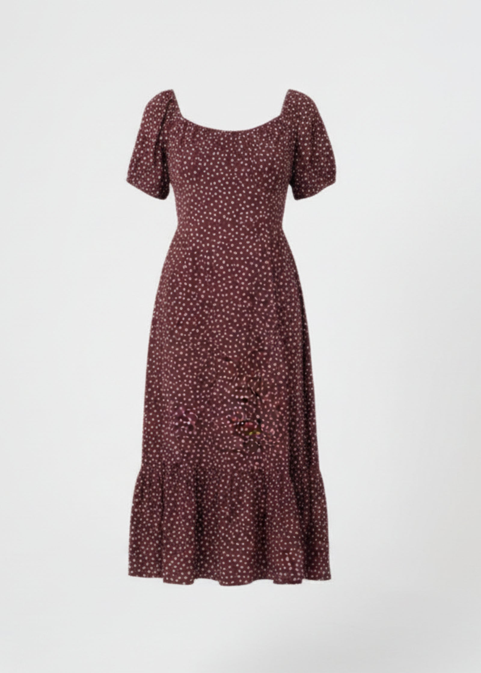 Woman wearing a chocolate dress with white polka dots on a white background