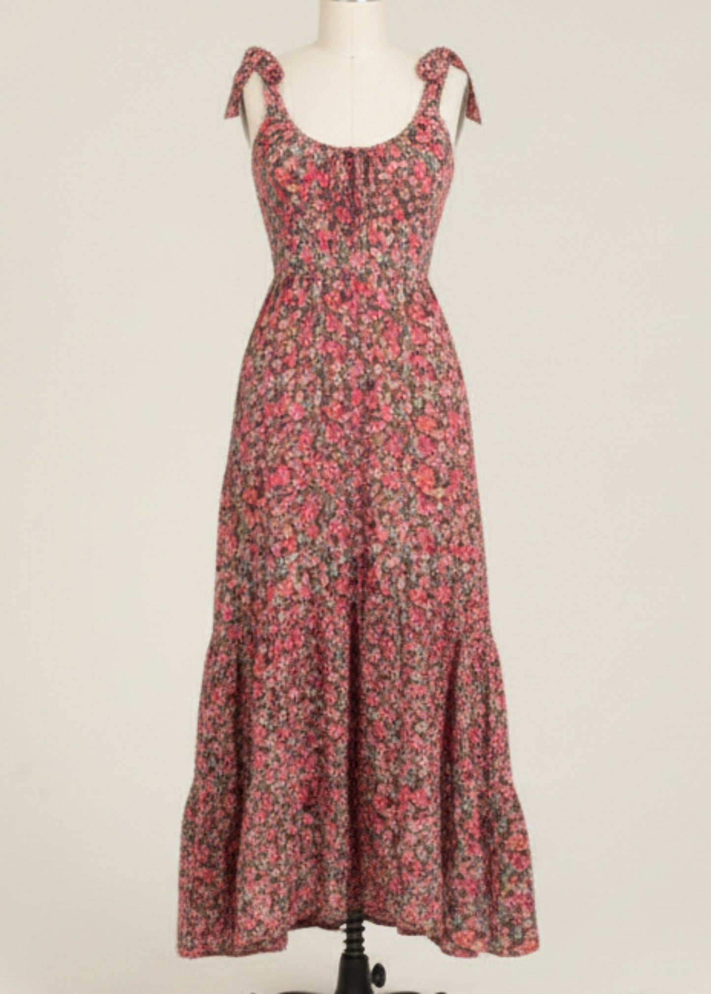 Woman wearing a floral dress on a plain background