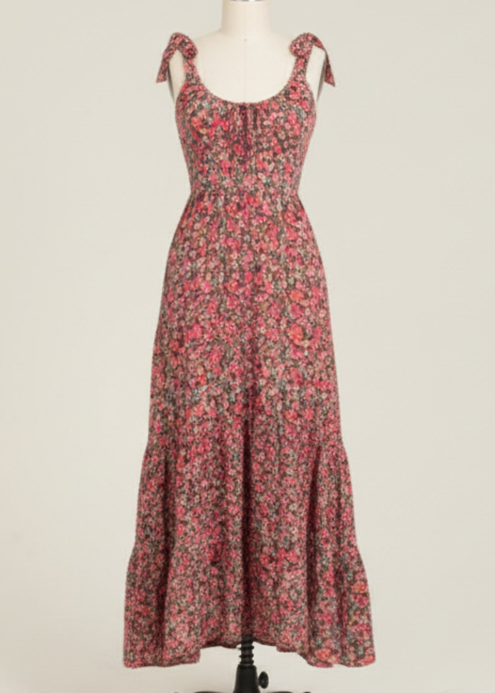 Woman wearing a floral dress on a plain background