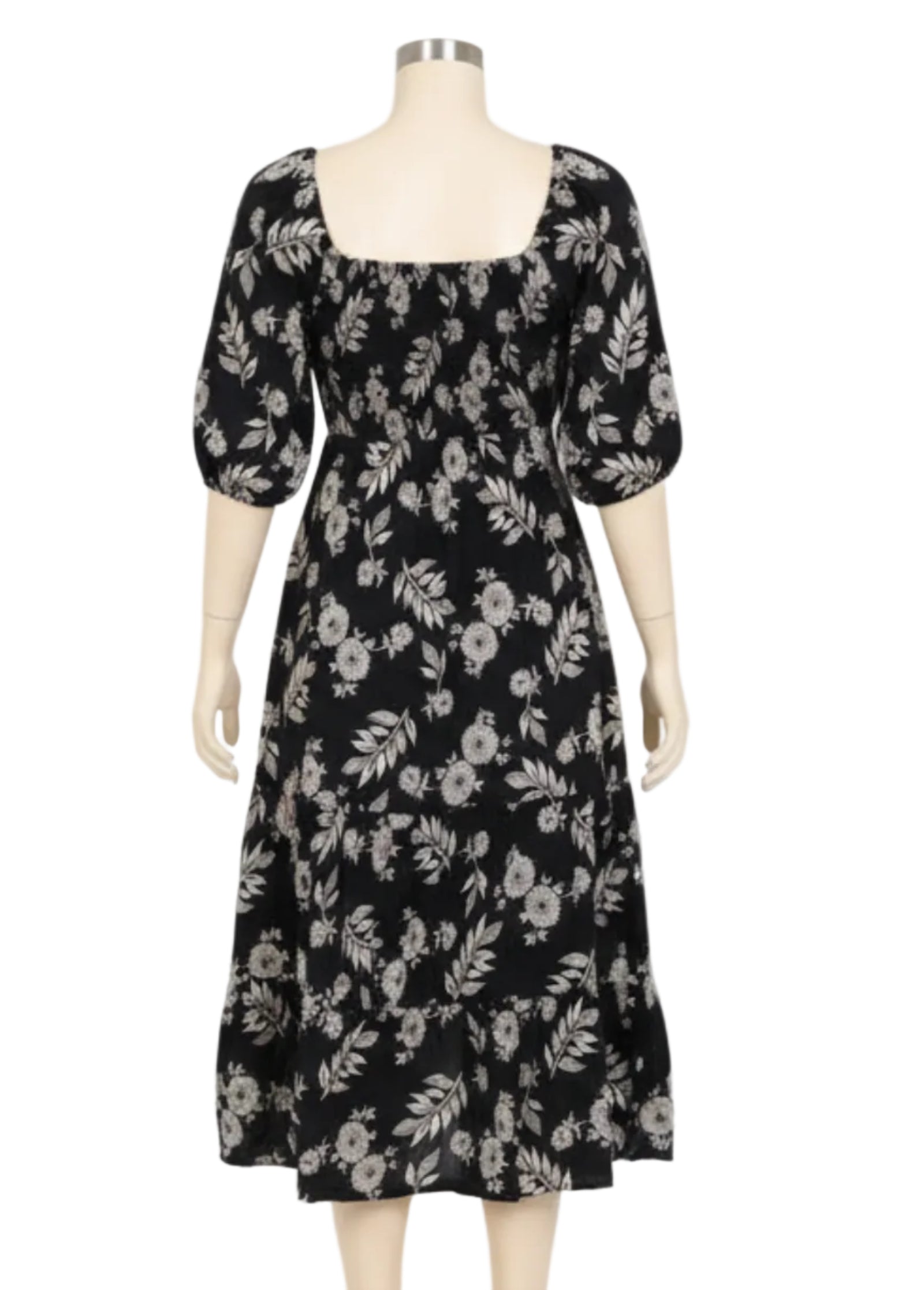Woman wearing a black floral dress on a white background