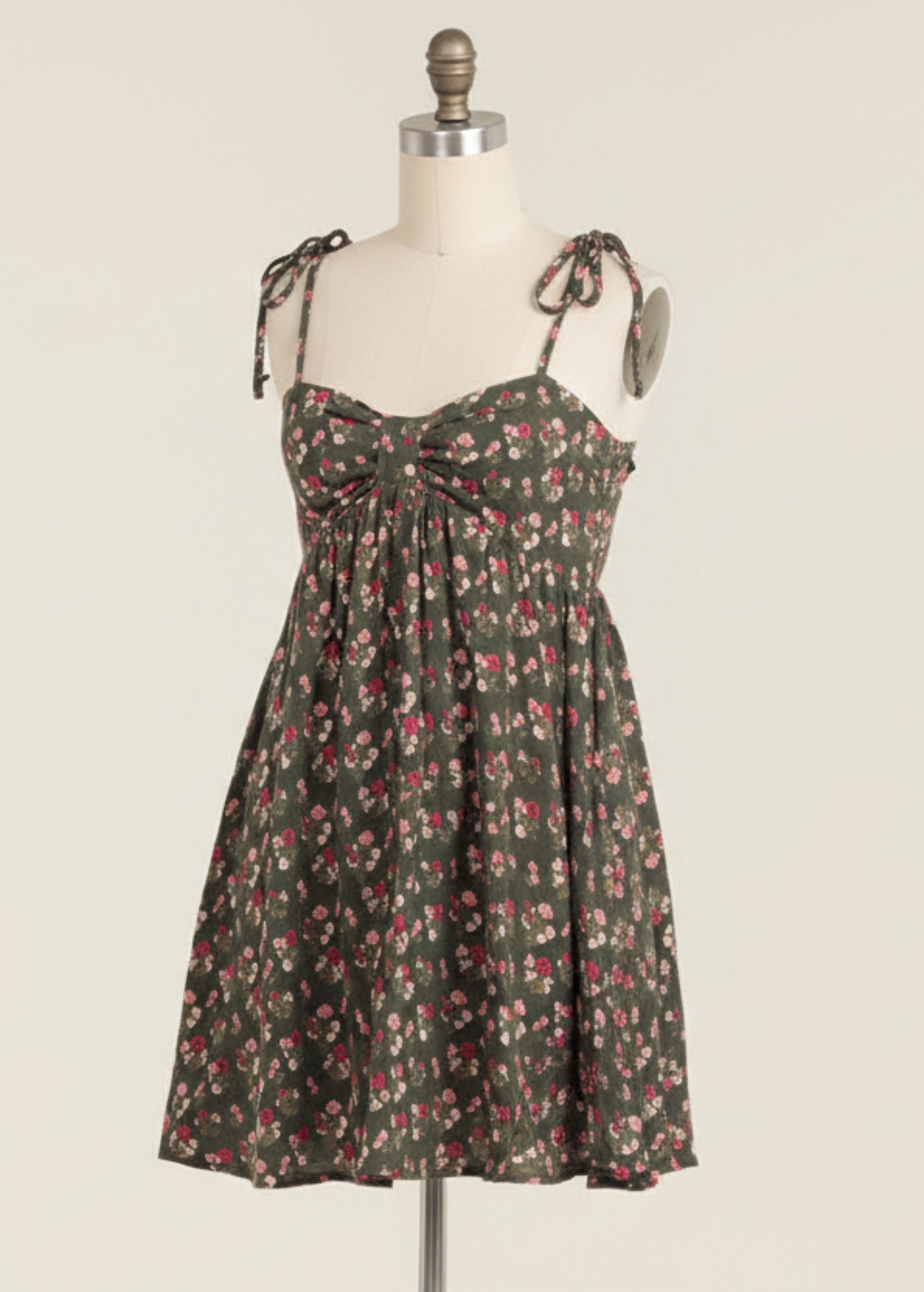 Woman wearing a floral dress on a beige background