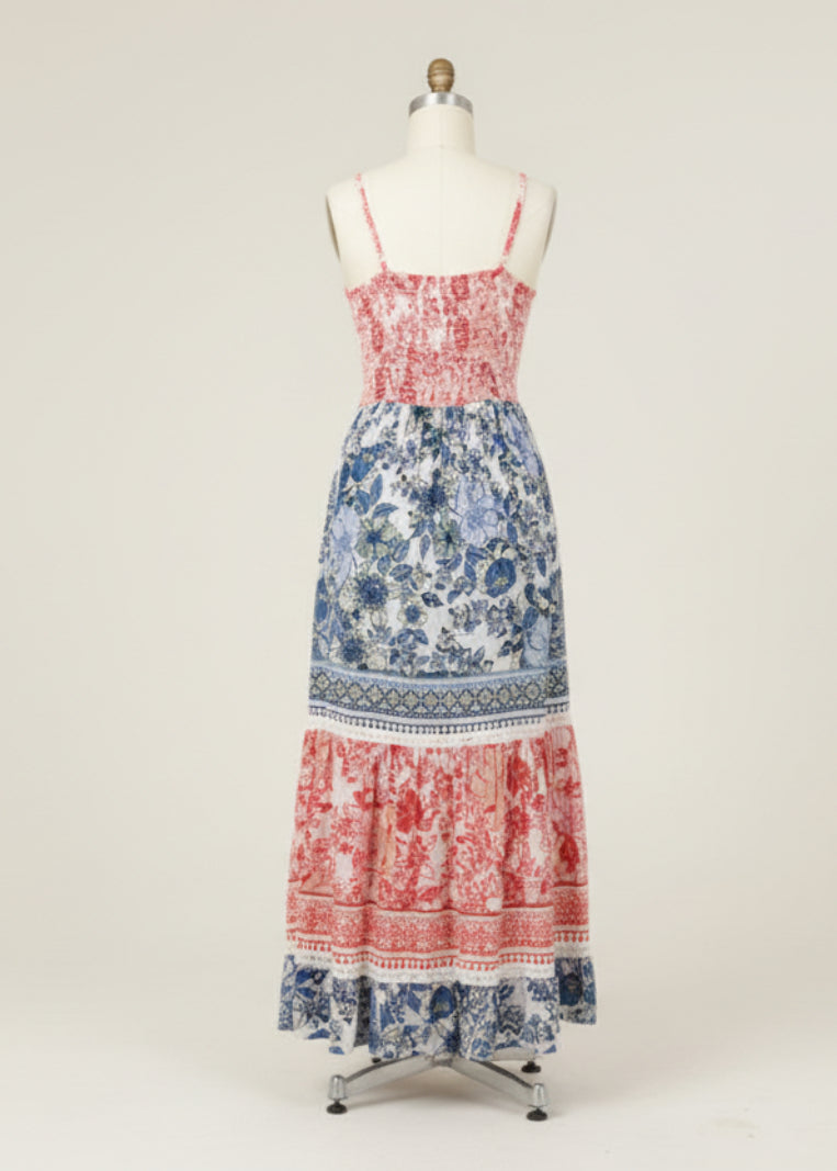 Woman wearing a colorful floral dress with a white background