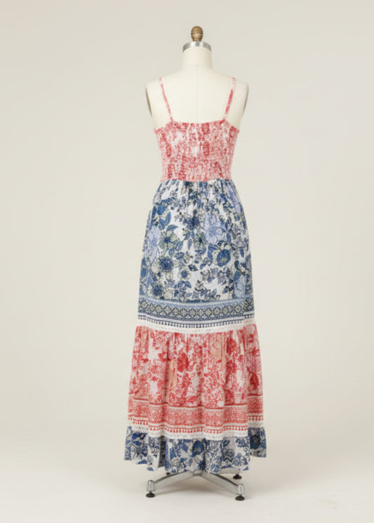 Woman wearing a colorful floral dress with a white background