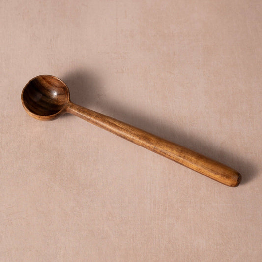 Overhead view of the Subah Wood Coffee Scoop showing its rounded bowl, long handle, and natural wood grain