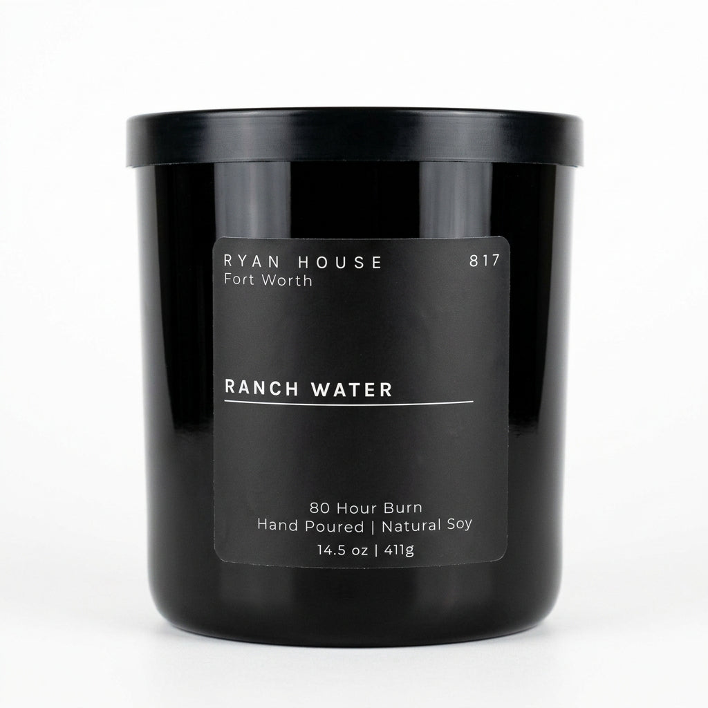Ryan House Ranch Water candle in an amber glass jar with a black lid and charcoal label showing 14.5 oz.