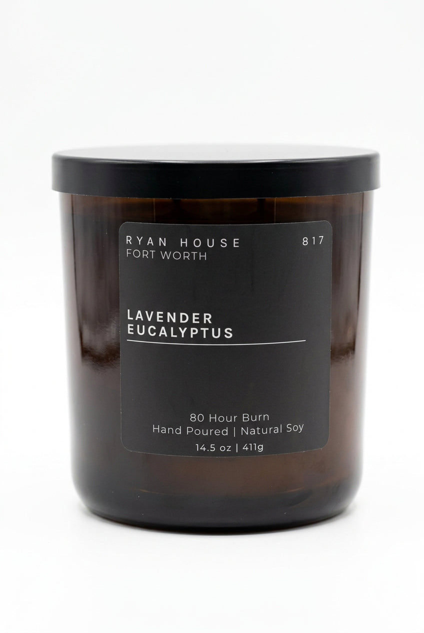 Ryan House Lavender Eucalyptus candle in an amber glass jar with a black lid and charcoal label showing 14.5 oz.