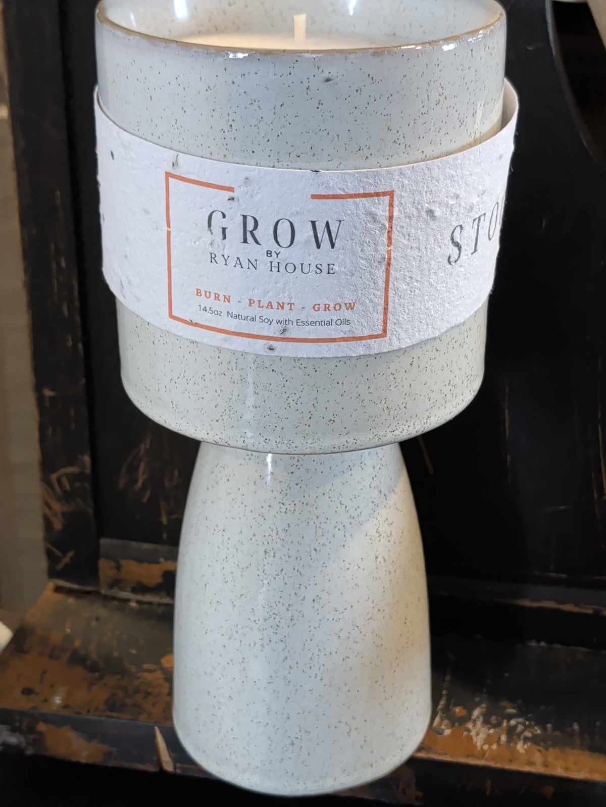 Ryan House Signature Stockyards Candle in a speckled ivory pedestal vessel with a GROW paper label