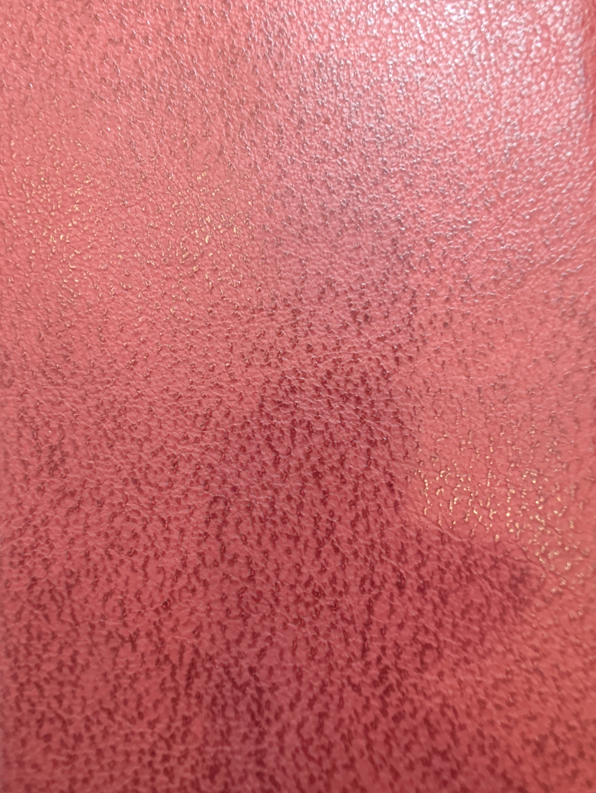 Red leather journal cover with a textured finish