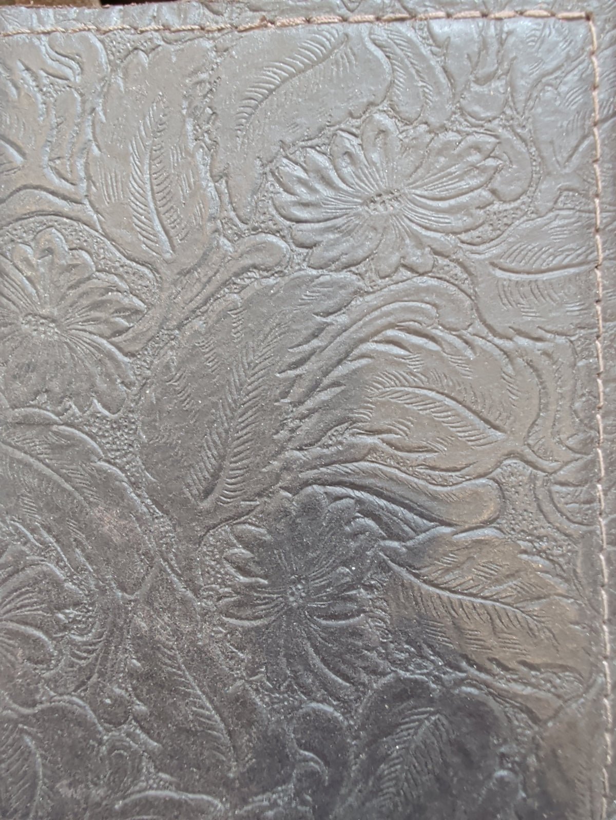  Brown leather journal cover with an embossed floral and leaf pattern