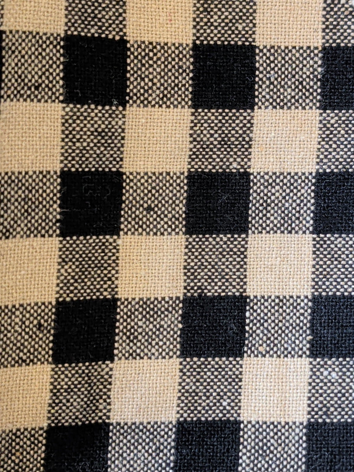 Close-up of Pip Vinestar kitchen towel fabric showing black and cream checks and woven texture