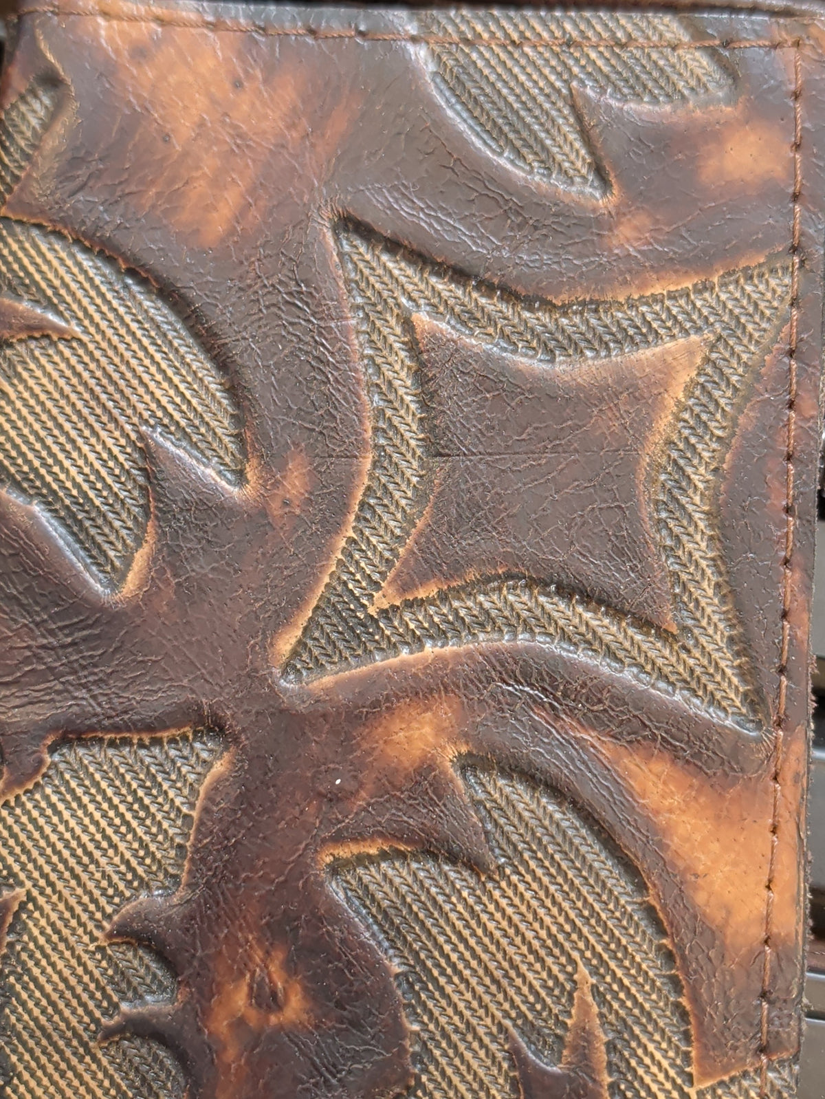  Brown leather journal cover with an embossed cross and scroll design