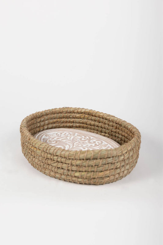Side view of the oval Toasty Bread Basket showing its natural woven sides and whitewashed terracotta insert