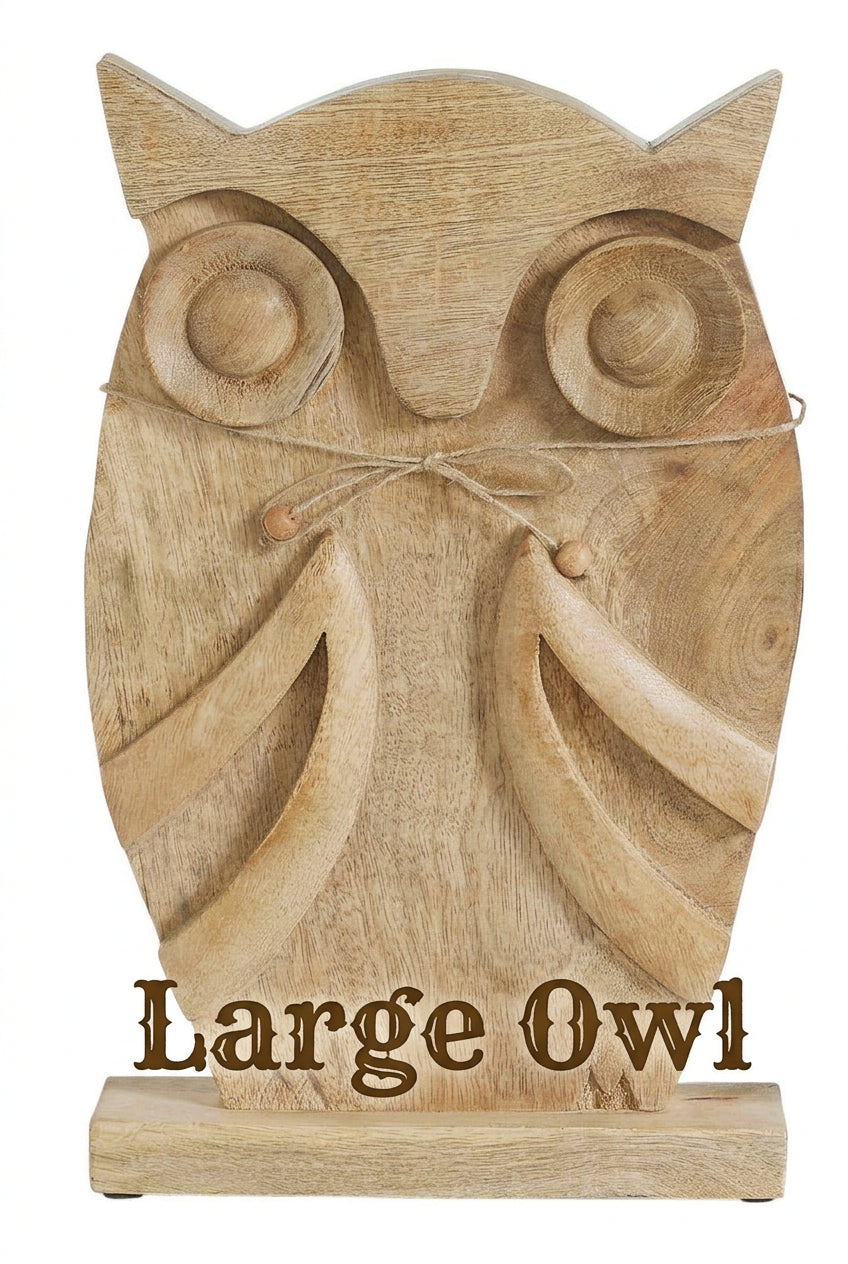  Front view of large carved mango wood owl figurine with round eyes, carved wings, and a beaded twine bow.