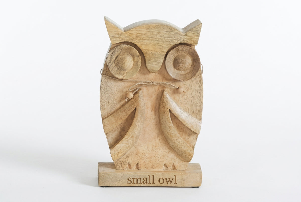Front view of small carved mango wood owl figurine with round eyes, carved wings, and a beaded twine bow.