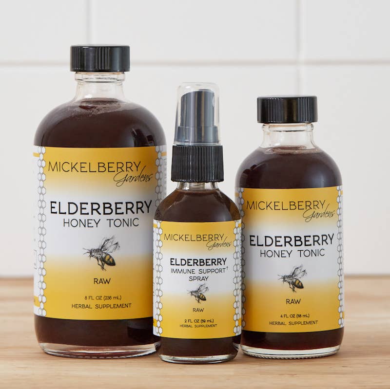 Mickelberry Gardens Elderberry Immune Support Spray beside 4 oz. and 8 oz. Elderberry Honey Tonic bottles