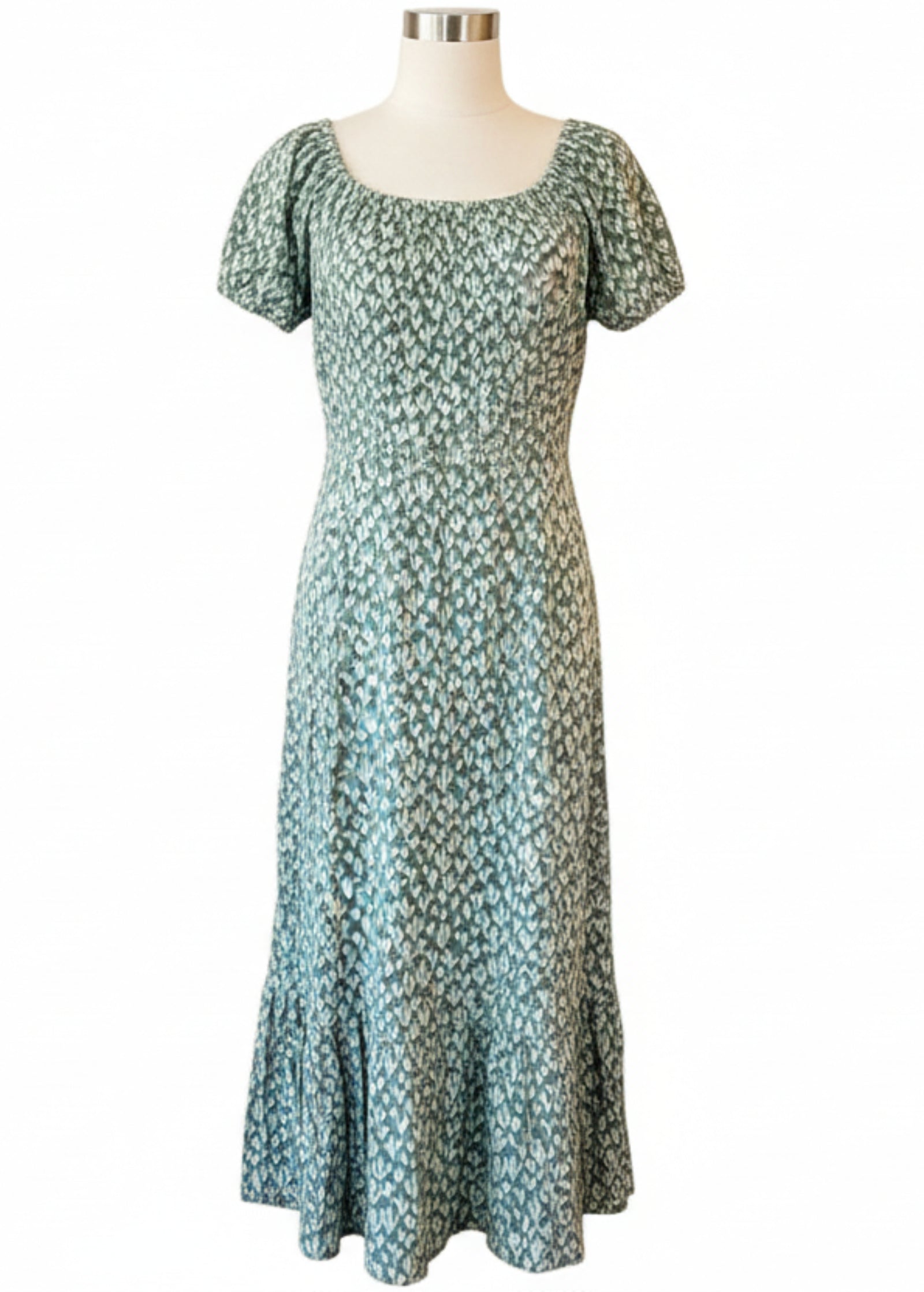 Green Cactus dress on a mannequin against a wooden panel background