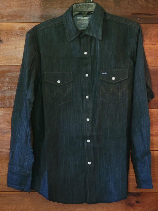 Dark denim shirt with white buttons on a wooden surface