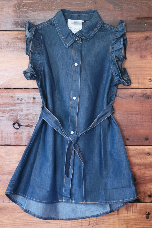 Blue denim dress on a wooden surface