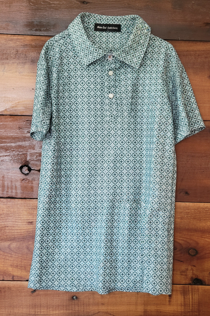 Green patterned shirt on a wooden surface