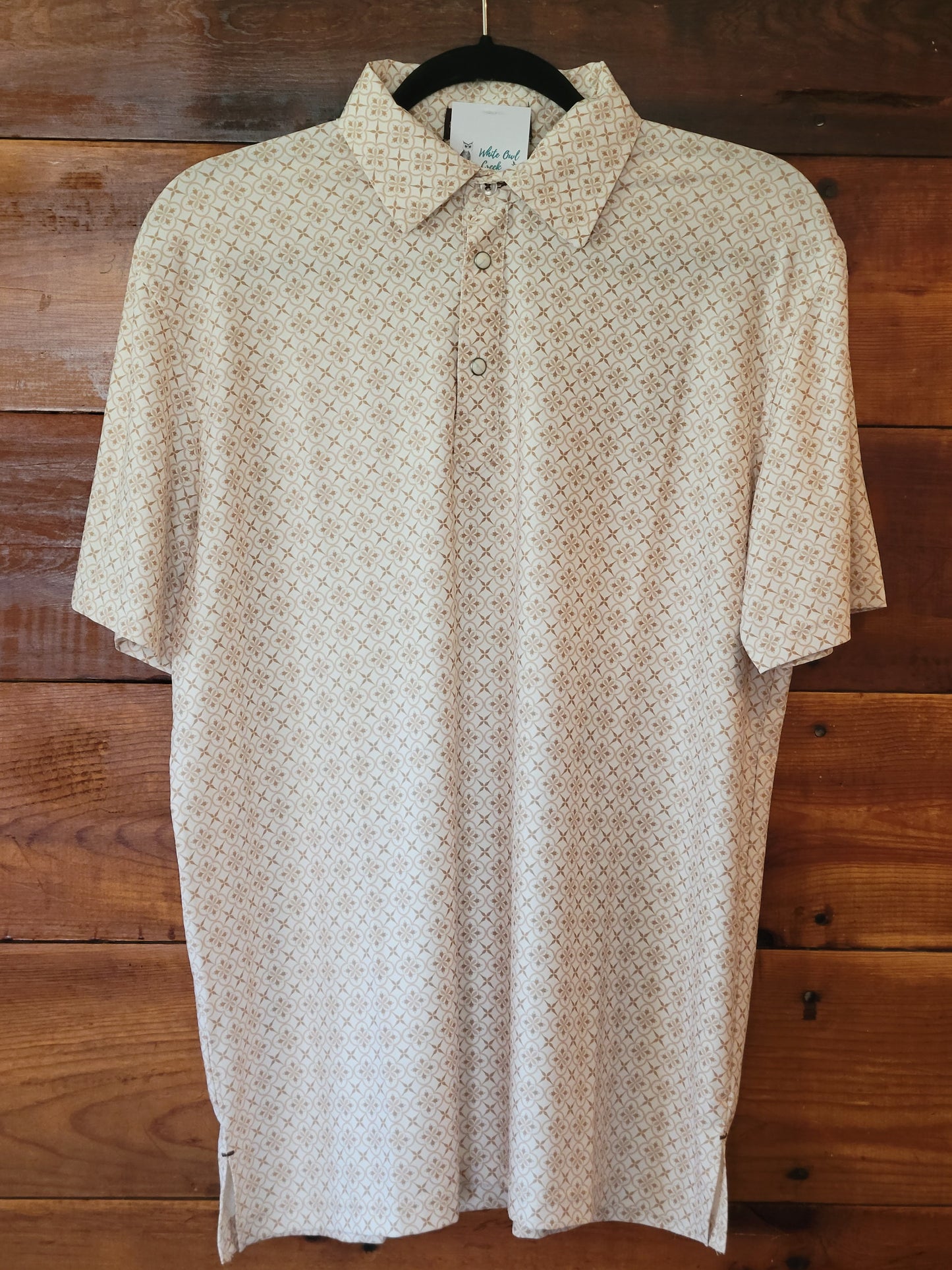 Beige patterned shirt on a wooden surface