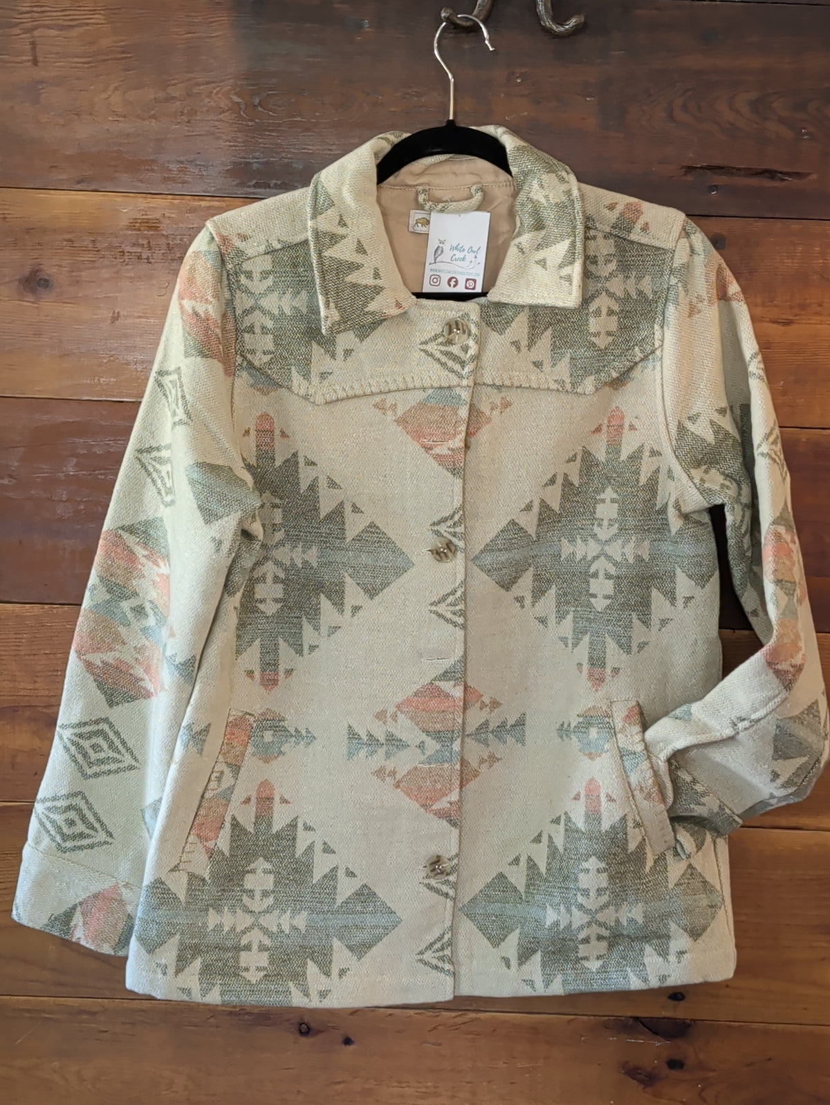 Front view of the Southwestern print Western yoke coat with a spread collar, button closure, and side pockets