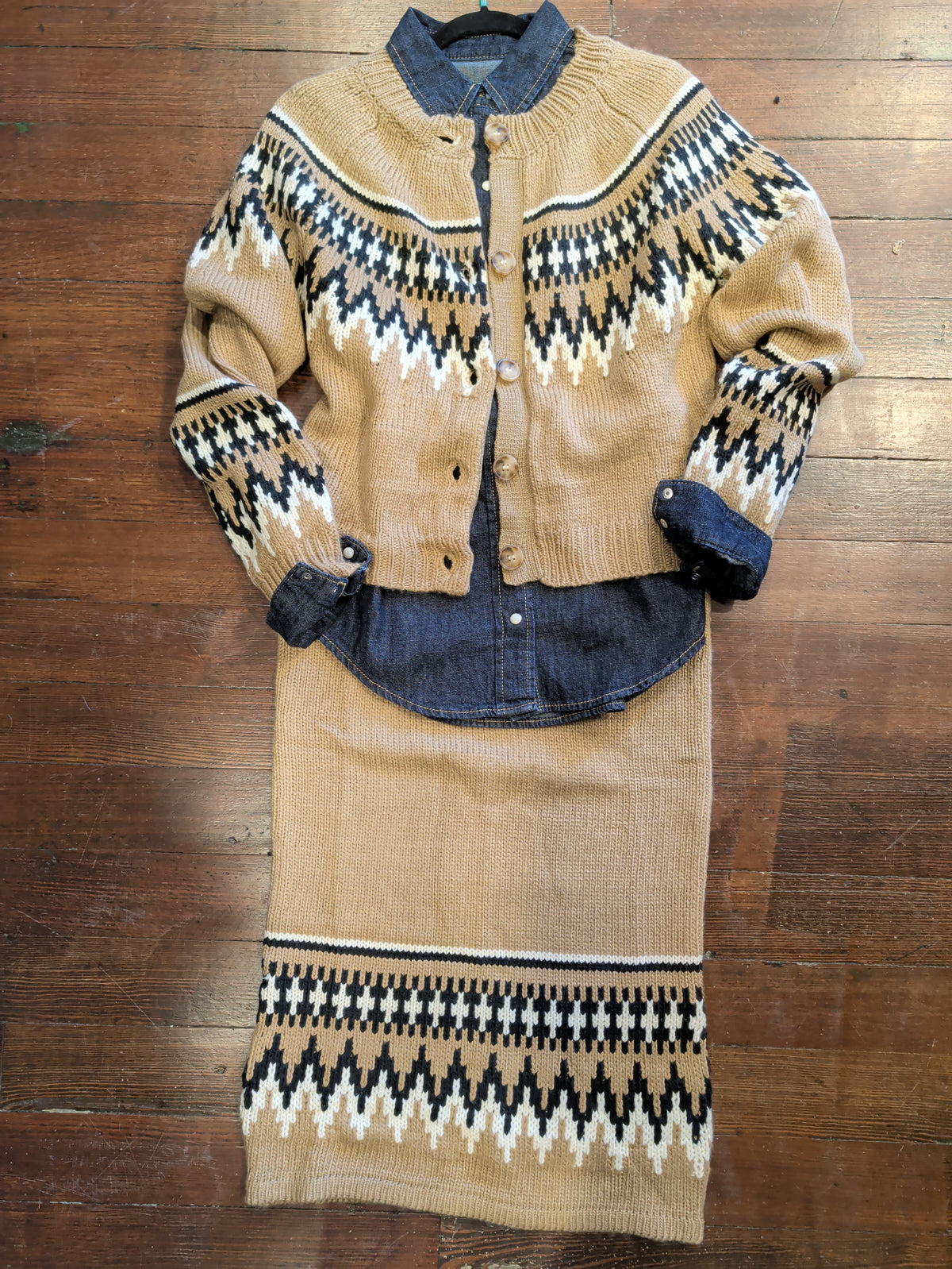 Light brown Fair Isle knit skirt styled with a matching cardigan over a dark denim shirt.